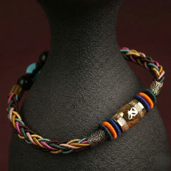 The "Infinite Peace" Bracelet for Women, Artisan-Woven Jewelry with Lucky Golden Charm - detail close-up view - Proyoo Handmade